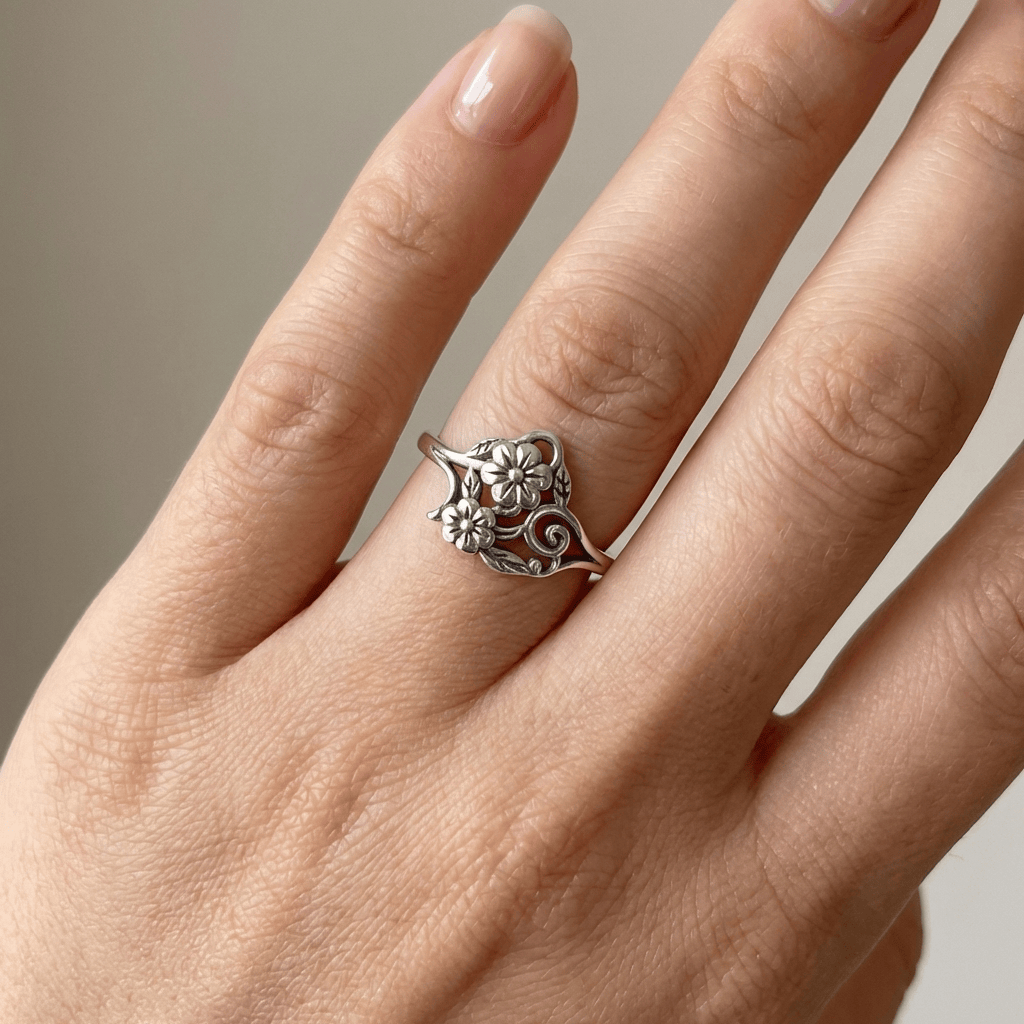 Anel Rose & Oliver de prata com detalhe de flor ornamentada e design delicado, ideal para uso elegante e feminino.