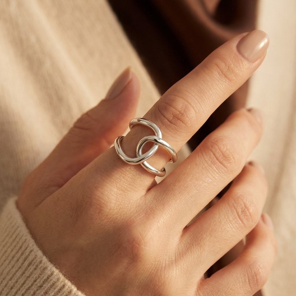 Anel prateado de aro aberto entrelaçado da Rose & Oliver, com design moderno e acabamento brilhante.